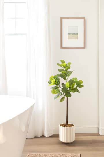 Kate and Laurel 4ft. Fidmont Faux Fiddle Fig Tree with White Planter